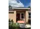 Inviting front porch with a red door, providing a warm welcome to the home at 7488 Sw 204Th Ave, Dunnellon, FL 34431