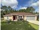 Charming single-story home featuring a well-maintained lawn and a cozy front entrance at 7488 Sw 204Th Ave, Dunnellon, FL 34431