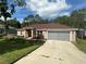 Attractive single-story home with a well-manicured lawn and a convenient two-car garage at 7488 Sw 204Th Ave, Dunnellon, FL 34431