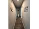 Hallway with wood-look flooring and neutral paint, providing a sense of flow and connection to other rooms at 7488 Sw 204Th Ave, Dunnellon, FL 34431