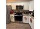 Modern kitchen boasts stainless steel appliances, white cabinetry and granite countertops at 7488 Sw 204Th Ave, Dunnellon, FL 34431