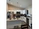 Kitchen boasts white cabinets, granite countertops, stainless steel appliances, and a functional center island at 7488 Sw 204Th Ave, Dunnellon, FL 34431