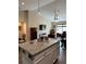 Open-concept living space with modern kitchen, granite island, and stainless steel appliances at 7488 Sw 204Th Ave, Dunnellon, FL 34431