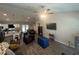 Open-concept living room with vaulted ceilings, ceiling fan, and views into the kitchen and dining area at 7488 Sw 204Th Ave, Dunnellon, FL 34431