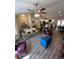 Bright and airy living area featuring open floor plan and stylish gray wood-look flooring at 7488 Sw 204Th Ave, Dunnellon, FL 34431