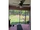 Enclosed screened porch with ceiling fan offering a relaxing outdoor space with backyard views at 7488 Sw 204Th Ave, Dunnellon, FL 34431
