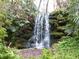 Charming waterfall cascading over natural rocks in a verdant, leafy setting at 7488 Sw 204Th Ave, Dunnellon, FL 34431