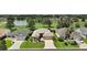 Inviting single-story home features a manicured lawn with mature trees, and landscaping in a well-kept neighborhood at 8545 Se 168Th Kittredge Loop, The Villages, FL 32162