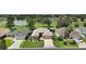 Desirable single-story home features a manicured lawn with mature trees, and landscaping in a well-kept neighborhood at 8545 Se 168Th Kittredge Loop, The Villages, FL 32162