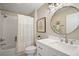Well-lit bathroom features a vanity, a toilet, and a shower tub with curtain at 8545 Se 168Th Kittredge Loop, The Villages, FL 32162