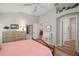 Bright bedroom showcases wood-look floors, a ceiling fan, and natural light through the window at 8545 Se 168Th Kittredge Loop, The Villages, FL 32162