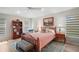 Cozy bedroom boasts an area rug, a ceiling fan, natural light, and comfortable furnishings at 8545 Se 168Th Kittredge Loop, The Villages, FL 32162