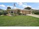 Well-maintained home with beautiful landscaping, mature palm trees, and a spacious driveway at 8545 Se 168Th Kittredge Loop, The Villages, FL 32162