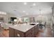Kitchen with an island connecting living spaces, stainless appliances, and natural light at 8545 Se 168Th Kittredge Loop, The Villages, FL 32162