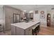 Bright and airy kitchen boasting an island with seating and stainless steel appliances for a chef-inspired space at 8545 Se 168Th Kittredge Loop, The Villages, FL 32162
