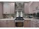 Modern kitchen with stainless steel appliances and stylish backsplash that complement the cabinetry at 8545 Se 168Th Kittredge Loop, The Villages, FL 32162