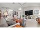 Inviting living room with a ceiling fan and large screen TV for a relaxing entertainment space at 8545 Se 168Th Kittredge Loop, The Villages, FL 32162