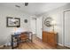Bright home office space features a desk, a wooden dresser, and a round mirror on the wall at 8545 Se 168Th Kittredge Loop, The Villages, FL 32162