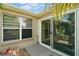 Cozy patio area with sliding glass doors and lush landscaping at 8545 Se 168Th Kittredge Loop, The Villages, FL 32162