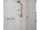 Close-up of the shower with sleek fixtures, a built-in bench, and safety grab bar at 8545 Se 168Th Kittredge Loop, The Villages, FL 32162
