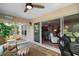 Open sunroom with floor-to-ceiling windows and patio access to the outside area at 8545 Se 168Th Kittredge Loop, The Villages, FL 32162