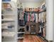 A walk-in closet provides ample storage with built-in shelving and hanging racks at 8545 Se 168Th Kittredge Loop, The Villages, FL 32162