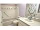 Cozy bathroom with tub/shower combo, updated vanity, and tiled accents at 8653 Sw 95Th Ln # F, Ocala, FL 34481