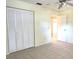 Bedroom with tiled floors, closet and natural light offering a comfortable space at 8653 Sw 95Th Ln # F, Ocala, FL 34481