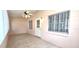 Charming Florida room with tile flooring, ceiling fan and natural light from windows at 8653 Sw 95Th Ln # F, Ocala, FL 34481
