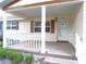 Inviting front porch with white railings and ample space for outdoor seating at 8653 Sw 95Th Ln # F, Ocala, FL 34481