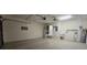 Spacious garage featuring high ceilings, and includes a utility sink, refrigerator and water heater at 8653 Sw 95Th Ln # F, Ocala, FL 34481