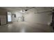 Large garage with ample space, featuring a utility sink, refrigerator and access to the interior at 8653 Sw 95Th Ln # F, Ocala, FL 34481