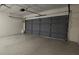 Spacious two-car garage with overhead lighting and automatic door in this home at 8653 Sw 95Th Ln # F, Ocala, FL 34481