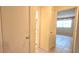 Hallway leading to rooms and bathroom with tiled floors at 8653 Sw 95Th Ln # F, Ocala, FL 34481