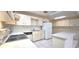 Traditional kitchen featuring white cabinetry, tiled floors, and a functional island counter at 8653 Sw 95Th Ln # F, Ocala, FL 34481