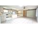 Bright kitchen featuring ample cabinet space, a center island, and essential appliances at 8653 Sw 95Th Ln # F, Ocala, FL 34481