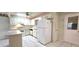 Bright kitchen includes white appliances and cabinetry, with a door to the outside at 8653 Sw 95Th Ln # F, Ocala, FL 34481
