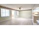 Open-concept living space with tile flooring and access to a kitchen area at 8653 Sw 95Th Ln # F, Ocala, FL 34481