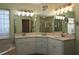 Bathroom featuring dual sinks, ample countertop space, and a separate glass-enclosed shower and bathtub at 9129 Sw 193Rd Cir, Dunnellon, FL 34432