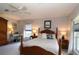 Sunlit bedroom with detailed wooden bed, two side tables, and neutral decor at 9129 Sw 193Rd Cir, Dunnellon, FL 34432