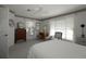 Bright bedroom featuring two windows, a ceiling fan, and neutral decor at 9129 Sw 193Rd Cir, Dunnellon, FL 34432
