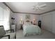 Bright bedroom featuring a ceiling fan, and a decorative floral painting above the bed at 9129 Sw 193Rd Cir, Dunnellon, FL 34432