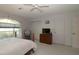Spacious bedroom with a dresser, TV, closet, and a sunlit window at 9129 Sw 193Rd Cir, Dunnellon, FL 34432