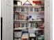 Well-organized closet with shelves full of books, binders, and storage boxes at 9129 Sw 193Rd Cir, Dunnellon, FL 34432