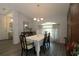 Elegant dining room with a table set for six, hardwood floors, and ample lighting at 9129 Sw 193Rd Cir, Dunnellon, FL 34432