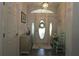 Inviting foyer with tile flooring, decorative door with sidelights, and neutral decor at 9129 Sw 193Rd Cir, Dunnellon, FL 34432