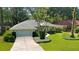 Well maintained single story home with two car garage, mature trees and healthy green grass at 9129 Sw 193Rd Cir, Dunnellon, FL 34432