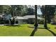 Charming single-story home boasts lush landscaping, a manicured lawn, and mature trees for enhanced curb appeal at 9129 Sw 193Rd Cir, Dunnellon, FL 34432