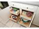 White kitchen cabinets with pull-out drawers, maximizing storage space for dishes and kitchen essentials at 9129 Sw 193Rd Cir, Dunnellon, FL 34432