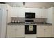 Bright kitchen featuring modern appliances and white cabinetry at 9129 Sw 193Rd Cir, Dunnellon, FL 34432